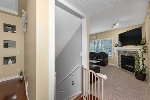 135 Kincora Drive Nw, Calgary, AB - Indoor Photo Showing Other Room With Fireplace