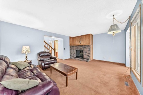 4008 46 Street Sw, Calgary, AB - Indoor Photo Showing Living Room With Fireplace
