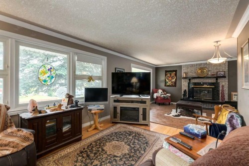 723 Trafford Drive Nw, Calgary, AB - Indoor Photo Showing Living Room With Fireplace