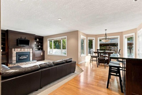70 Sunset Way Se, Calgary, AB - Indoor Photo Showing Living Room With Fireplace