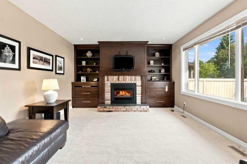 70 Sunset Way Se, Calgary, AB - Indoor Photo Showing Other Room With Fireplace