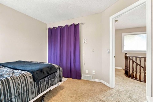 70 Sunset Way Se, Calgary, AB - Indoor Photo Showing Bedroom