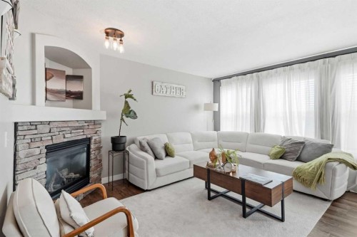 138 Somerglen Common Sw, Calgary, AB - Indoor Photo Showing Living Room With Fireplace