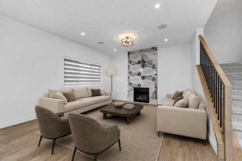 124 Heritage Boulevard, Cochrane, AB - Indoor Photo Showing Living Room With Fireplace