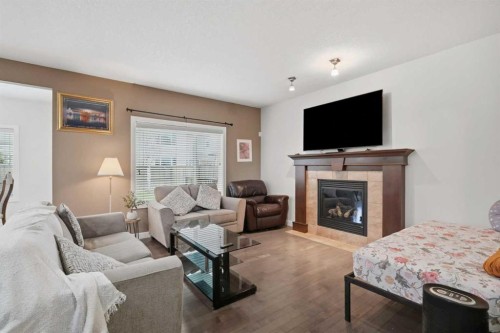 509 New Brighton Drive Se, Calgary, AB - Indoor Photo Showing Living Room With Fireplace