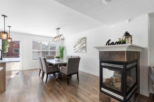 17 Auburn Bay View Se, Calgary, AB - Indoor Photo Showing Dining Room With Fireplace