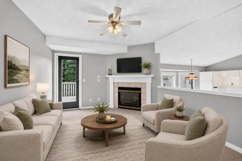 23 Sunlake Gardens Se, Calgary, AB - Indoor Photo Showing Living Room With Fireplace