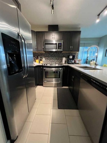 409-1320 1 Street Se, Calgary, AB - Indoor Photo Showing Kitchen With Stainless Steel Kitchen With Double Sink