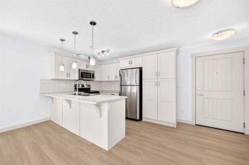 2105-450 Sage Valley Drive Nw, Calgary, AB - Indoor Photo Showing Kitchen With Stainless Steel Kitchen With Upgraded Kitchen