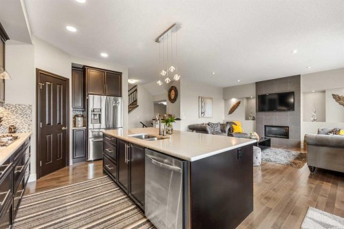 183 Aspen Acres Manor Sw, Calgary, AB - Indoor Photo Showing Kitchen With Fireplace With Stainless Steel Kitchen With Double Sink With Upgraded Kitchen