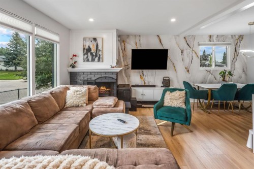 703 Millar Road Ne, Calgary, AB - Indoor Photo Showing Living Room With Fireplace