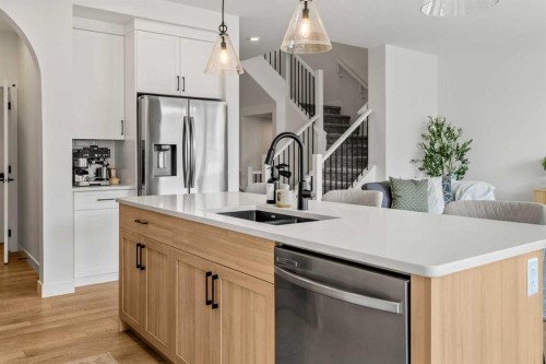 62 Southborough Crescent, Cochrane, AB - Indoor Photo Showing Kitchen With Double Sink With Upgraded Kitchen