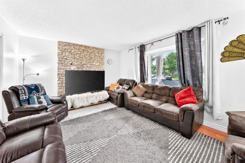 983 Rundlecairn Way Ne, Calgary, AB - Indoor Photo Showing Living Room With Fireplace