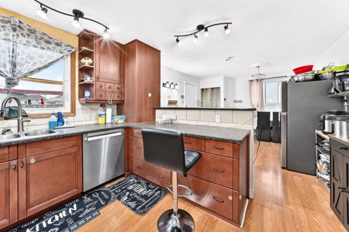 983 Rundlecairn Way Ne, Calgary, AB - Indoor Photo Showing Kitchen With Double Sink