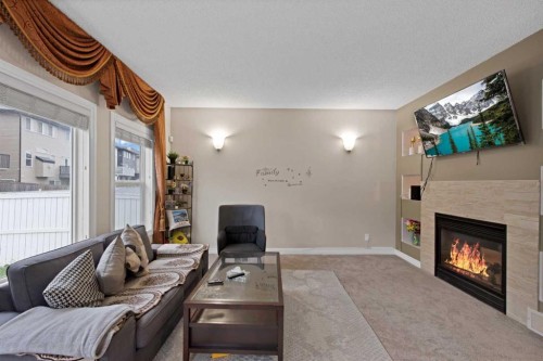 77 Saddleland Drive Ne, Calgary, AB - Indoor Photo Showing Living Room With Fireplace