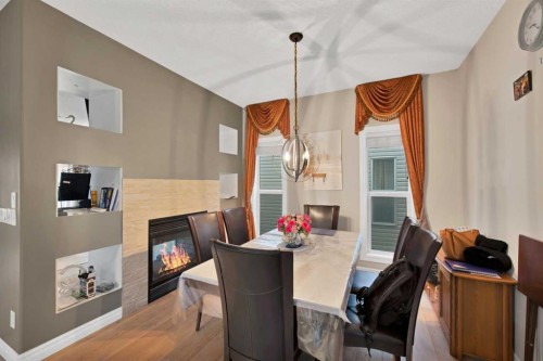 77 Saddleland Drive Ne, Calgary, AB - Indoor Photo Showing Dining Room With Fireplace