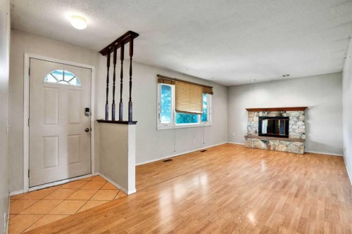 888 Rundlecairn Way Ne, Calgary, AB - Indoor Photo Showing Living Room With Fireplace