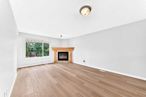 352 Copperfield Gardens Se, Calgary, AB - Indoor Photo Showing Living Room With Fireplace