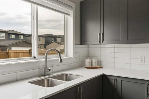 12 Wolf Creek Drive Se, Calgary, AB - Indoor Photo Showing Kitchen With Double Sink
