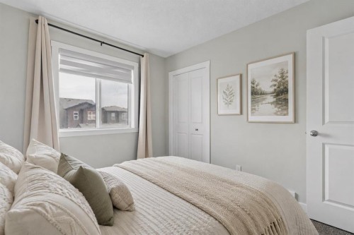 12 Wolf Creek Drive Se, Calgary, AB - Indoor Photo Showing Bedroom