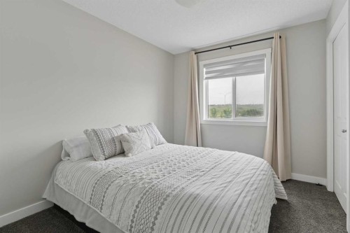 12 Wolf Creek Drive Se, Calgary, AB - Indoor Photo Showing Bedroom