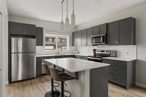 12 Wolf Creek Drive Se, Calgary, AB - Indoor Photo Showing Kitchen With Stainless Steel Kitchen With Upgraded Kitchen