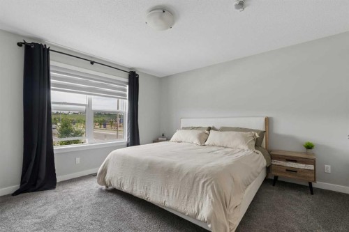 12 Wolf Creek Drive Se, Calgary, AB - Indoor Photo Showing Bedroom