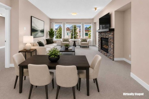 537-10 Discovery Ridge Close Sw, Calgary, AB - Indoor Photo Showing Dining Room With Fireplace