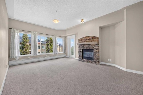 537-10 Discovery Ridge Close Sw, Calgary, AB - Indoor Photo Showing Living Room With Fireplace