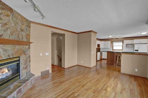62 West Mitford Crescent, Cochrane, AB - Indoor Photo Showing Living Room With Fireplace