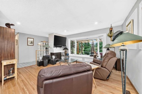 728 Willacy Drive Se, Calgary, AB - Indoor Photo Showing Living Room With Fireplace