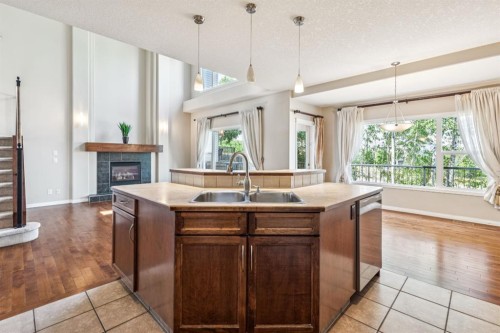 91 St Moritz Terrace Sw, Calgary, AB - Indoor Photo Showing Kitchen With Fireplace With Double Sink