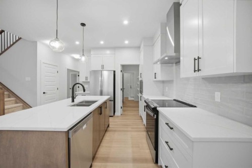 145 Topaz Place, Cochrane, AB - Indoor Photo Showing Kitchen With Double Sink With Upgraded Kitchen