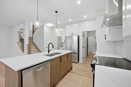 145 Topaz Place, Cochrane, AB - Indoor Photo Showing Kitchen With Double Sink With Upgraded Kitchen