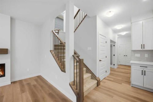 145 Topaz Place, Cochrane, AB - Indoor Photo Showing Other Room With Fireplace