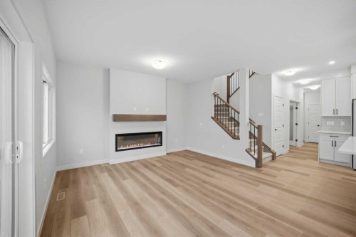 145 Topaz Place, Cochrane, AB - Indoor Photo Showing Living Room With Fireplace