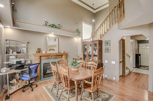 124 Del Ray Close Ne, Calgary, AB - Indoor Photo Showing Dining Room With Fireplace