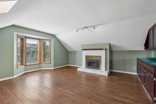 728 Shawnee Drive Sw, Calgary, AB - Indoor Photo Showing Living Room With Fireplace