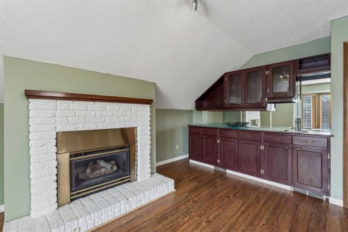 728 Shawnee Drive Sw, Calgary, AB - Indoor Photo Showing Living Room With Fireplace