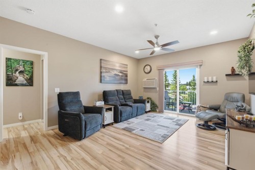 207-72 Quigley Drive, Cochrane, AB - Indoor Photo Showing Living Room