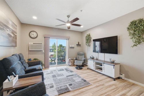 207-72 Quigley Drive, Cochrane, AB - Indoor Photo Showing Living Room