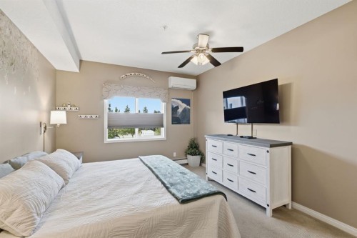 207-72 Quigley Drive, Cochrane, AB - Indoor Photo Showing Bedroom