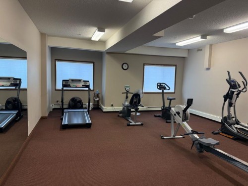 207-72 Quigley Drive, Cochrane, AB - Indoor Photo Showing Gym Room