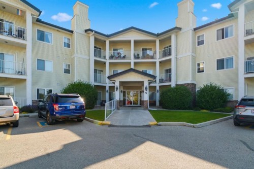 207-72 Quigley Drive, Cochrane, AB - Outdoor With Facade