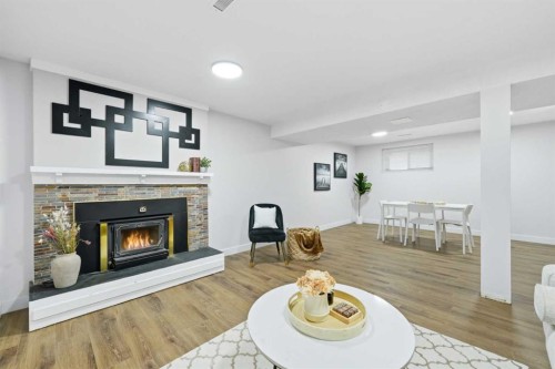 2220 Paliswood Road Sw, Calgary, AB - Indoor Photo Showing Living Room With Fireplace