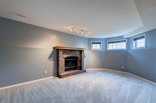 411 Shawinigan Drive Sw, Calgary, AB - Indoor Photo Showing Living Room With Fireplace