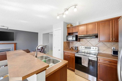 78 Cougar Plateau Way Sw, Calgary, AB - Indoor Photo Showing Kitchen With Double Sink