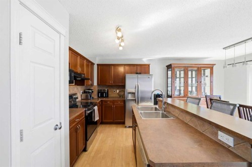 78 Cougar Plateau Way Sw, Calgary, AB - Indoor Photo Showing Kitchen With Double Sink