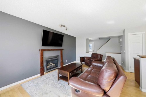 78 Cougar Plateau Way Sw, Calgary, AB - Indoor Photo Showing Living Room With Fireplace