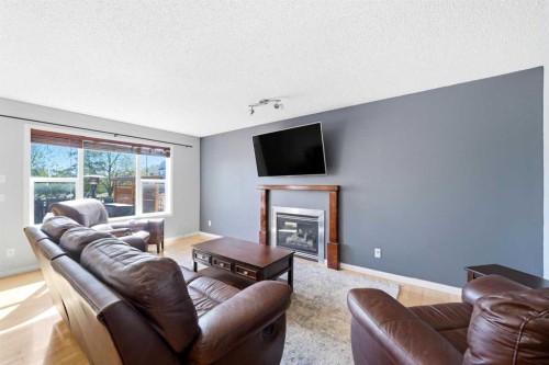 78 Cougar Plateau Way Sw, Calgary, AB - Indoor Photo Showing Living Room With Fireplace